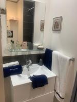 a bathroom with a sink with a mirror and towels at Mon rêve in Les Martys