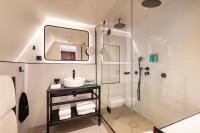 a bathroom with a shower and a sink and a mirror at Le 12 Hôtel in Paris