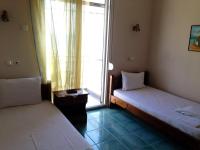 A bed or beds in a room at Hotel Prinos