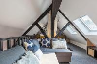 a living room with a couch in the attic at Le Phare Bleu - near center &amp; beach - 2 to 4 P in Honfleur