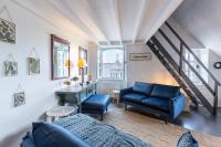 a living room with blue furniture and a staircase at Le Phare Bleu - near center &amp; beach - 2 to 4 P in Honfleur