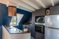 a kitchen with blue walls and a white refrigerator at Le Phare Bleu - near center &amp; beach - 2 to 4 P in Honfleur