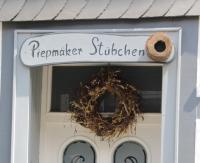 a sign on a door with a wreath on it at Piepmäker Stübchen in Goslar