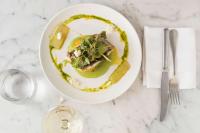 a plate with a dish of food on a table at Sails Port Macquarie by Rydges in Port Macquarie