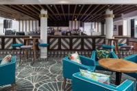 a lobby with blue chairs and a bar at Sails Port Macquarie by Rydges in Port Macquarie