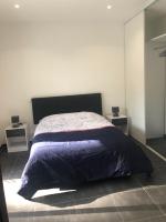 a bedroom with a bed and two night stands at T3 moderne et spacieux à BASTIA in Bastia
