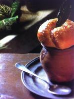 a pastry in a cup on a plate with a spoon at Les Pastels in La Roche-sur-Yon