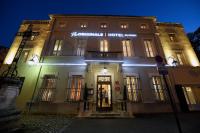 a building with a sign on the front of it at night at The Originals Boutique, Hôtel du Parc, Cavaillon (Inter-Hotel) in Cavaillon