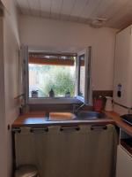a kitchen with a sink and a window at Un jardin en ville in Talence