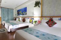 a bedroom with three beds and a painting on the wall at Xiang Heng House in Luodong