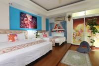 a hotel room with two beds and a painting on the wall at Xiang Heng House in Luodong