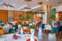 a dining room with tables and chairs and plants at Terminus City Center Oujda in Oujda