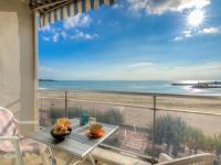 a balcony with a table and a view of the beach at Apartment Les Autans by Interhome in Royan