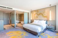 a bedroom with a large bed and a bathroom at Crowne Plaza Vientiane by IHG in Vientiane