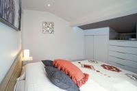 a bedroom with a bed with pillows on it at ONLOC - St Exupéry -Magnifique appart au calme avec chambre - parking in Pau