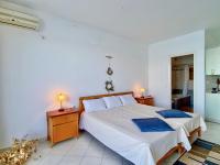 A bed or beds in a room at SeaFront Villa Ourania