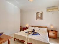 A bed or beds in a room at SeaFront Villa Ourania