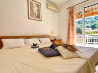 A bed or beds in a room at SeaFront Villa Ourania