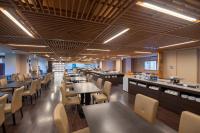 a dining room with tables and chairs and counters at Tazawako Lake Resort & Onsen in Senboku