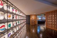 a room with a display of plates on the wall at Tazawako Lake Resort & Onsen in Senboku