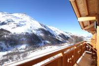 a balcony with a view of a snow covered mountain at Odalys Chalet D&#39;Alice in Les Menuires