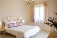 Postel nebo postele na pokoji v ubytování Ionian Luxury Villas