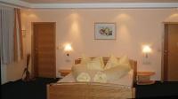 a bedroom with a bed with white sheets and pillows at Retzerlandhof Familie Graf in Zellerndorf