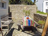 a table and a bench with a towel on it at Maison d&#39;une chambre a Tredrez Locquemeau a 800 m de la plage avec jardin amenage et wifi in Coat-Tredrez
