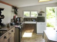 a kitchen with a sink and a microwave at Maison d&#39;une chambre a Tredrez Locquemeau a 800 m de la plage avec jardin amenage et wifi in Coat-Tredrez