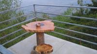 a wooden table with a cup on top of a balcony at Green Ark Resorts in Thekkady