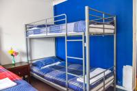 two bunk beds in a room with a blue wall at Gatwick Castle B&B in Horley