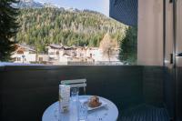 a table with a plate of food on a balcony at Résidence Grand Roc - Bruyères 022 - Happy Rentals in Chamonix