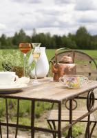 a table with a tea kettle and glasses of wine at Tertin Kartano in Mikkeli