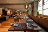 a dining room with a table and a bar at Die Reichsstadt - Hotel Spa und Restaurant in Gengenbach