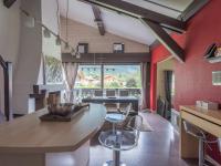 a kitchen with red walls and a wooden table and chairs at Appartement Chamonix-Mont-Blanc, 4 pièces, 6 personnes - FR-1-517-11 in Chamonix