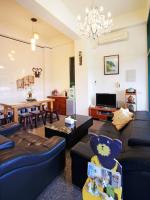 a living room with a couch and a dining room at Green Window Homestay in Hualien City