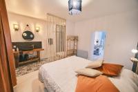 a bedroom with a large bed and a fireplace at Chez Nico et Anne in Deyvillers