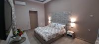 A bed or beds in a room at Vacanze Napoletane