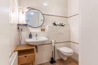 a bathroom with a sink and a toilet and a mirror at Villa Eltins in Bad Bentheim