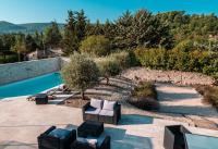 a patio with furniture and a swimming pool at Le Petit Rossignol in Apt