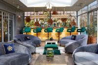 a waiting room with blue chairs and a barber shop at Farma Bii in Brzeziny