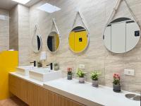 a bathroom with two sinks and mirrors on the wall at Yong Guan in Yuchi