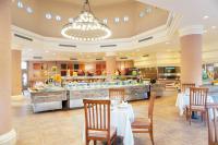 a restaurant with tables and chairs and a buffet at Charmillion Gardens Aquapark in Sharm El Sheikh