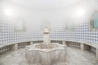 a fountain in a room with a tiled wall at Charmillion Gardens Aquapark in Sharm El Sheikh