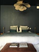 a bedroom with a large bed with a ceiling fan at Le Domaine de l&#39;Hostellerie in Le Fresne-Camilly