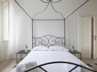 A bed or beds in a room at Bacone Liberty Vittoria by Halldis