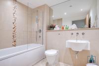 a bathroom with a sink and a toilet and a bath tub at City View Apartments Birmingham City Centre in Birmingham