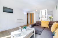 a living room with a couch and a table at City View Apartments Birmingham City Centre in Birmingham