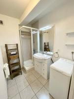 a bathroom with a sink and a shower and a toilet at Charmant T2 À 50m de locéan in Ploemeur