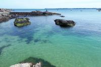 a large body of water with rocks in it at Spacieux appartement neuf de standing Hyper Cosy in Larmor-Plage